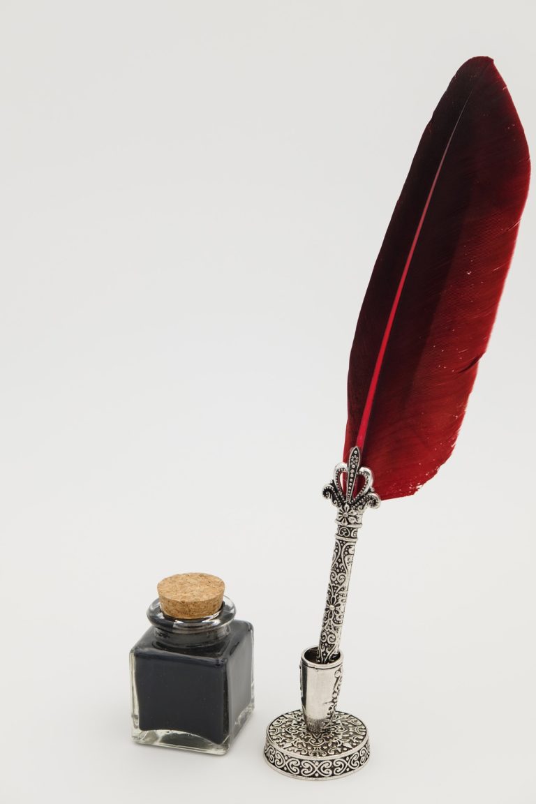 Imagen de una pluma con un frasco de tinta