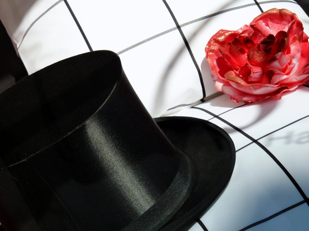 Imagen de un sombrero y una flor marchita